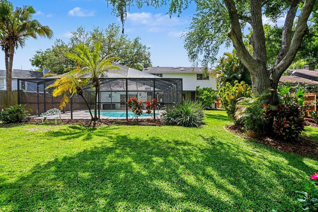 Screened pool and landscaped backyard in a Tampa Bay pool home